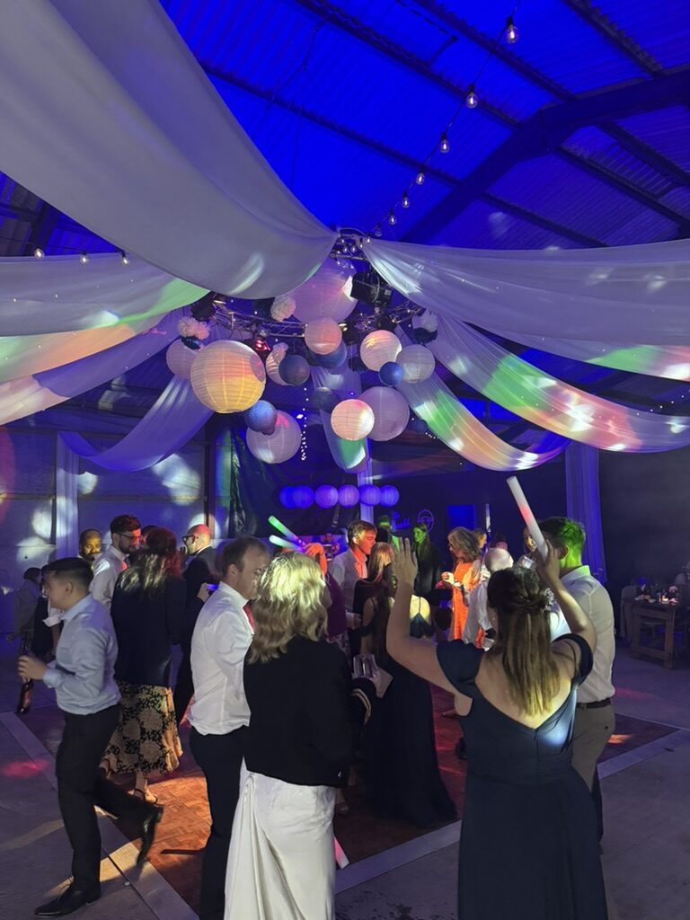 Wedding guests enjoying a colourful barn party