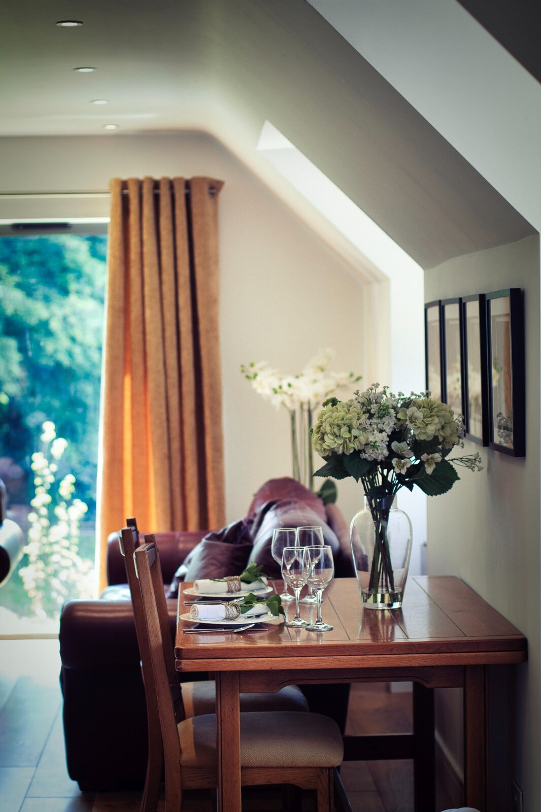 Dining table and flowers in the farmhouse at Hewletts Farm